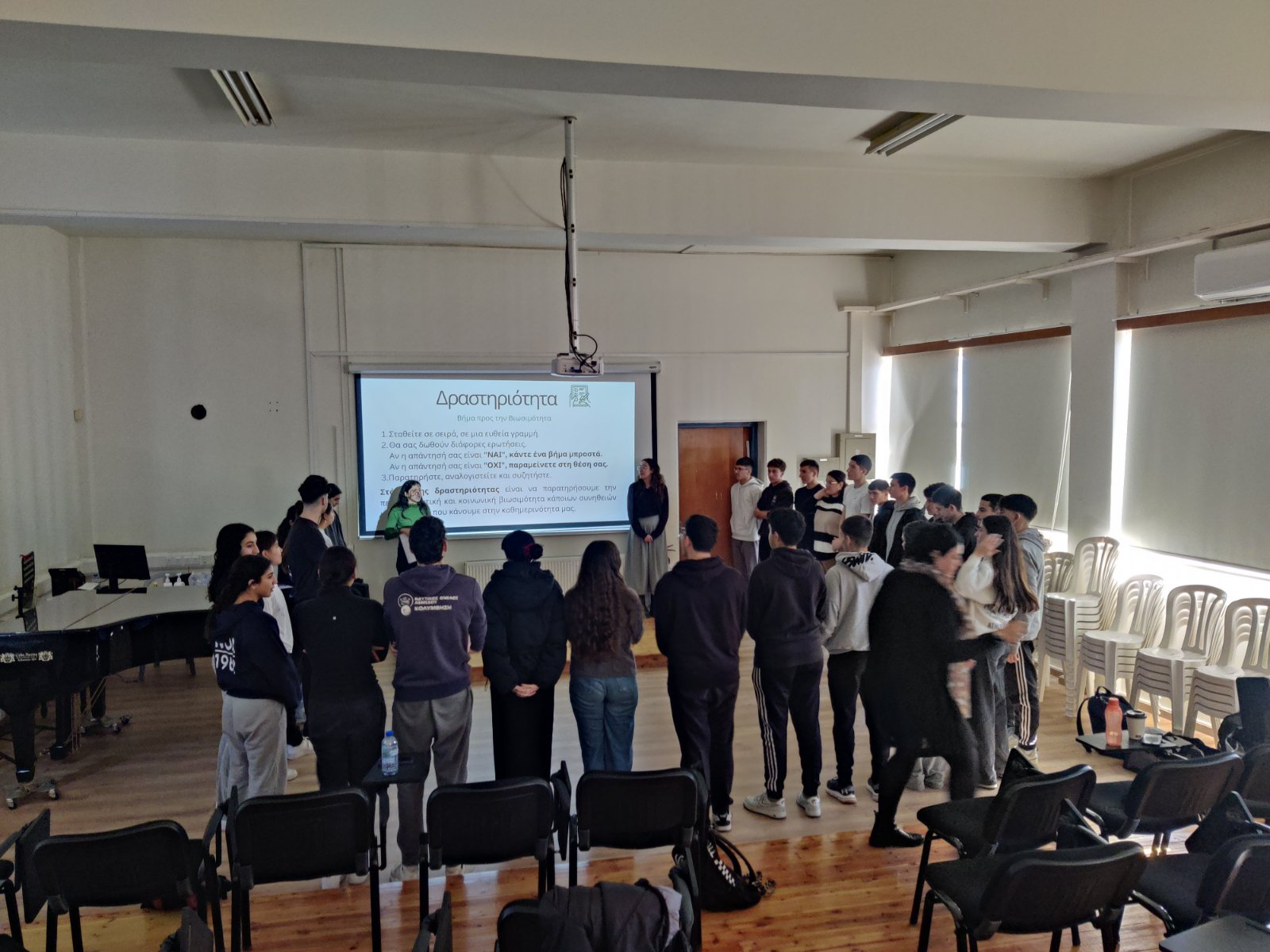 Interactive workshop with a group of people standing and engaging near a projected screen.
